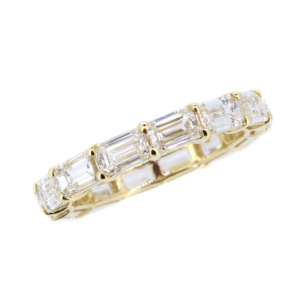 14KT yellow gold eternity band with 3.50ctw emerald cut diam...