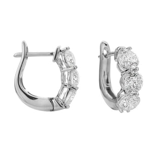 18KT white gold three stone hoop earrings with 2.00ctw round...