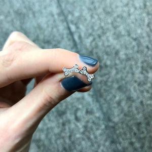 18KT white gold dog bone earrings with 0.15ctw round diamond...