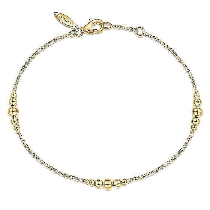 14KT yellow gold chain bracelet with graduated bead stations...