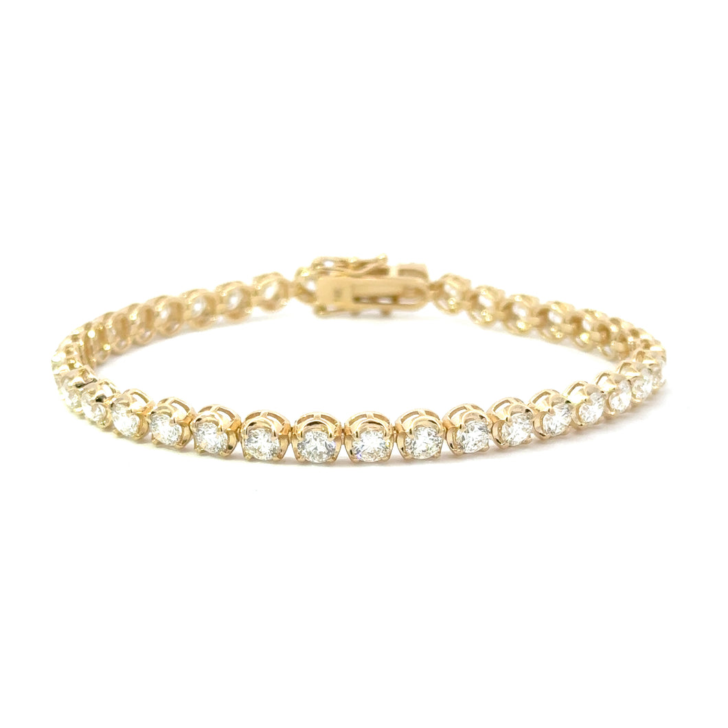 14KT yellow gold tennis bracelet with 7.01ctw round diamonds...